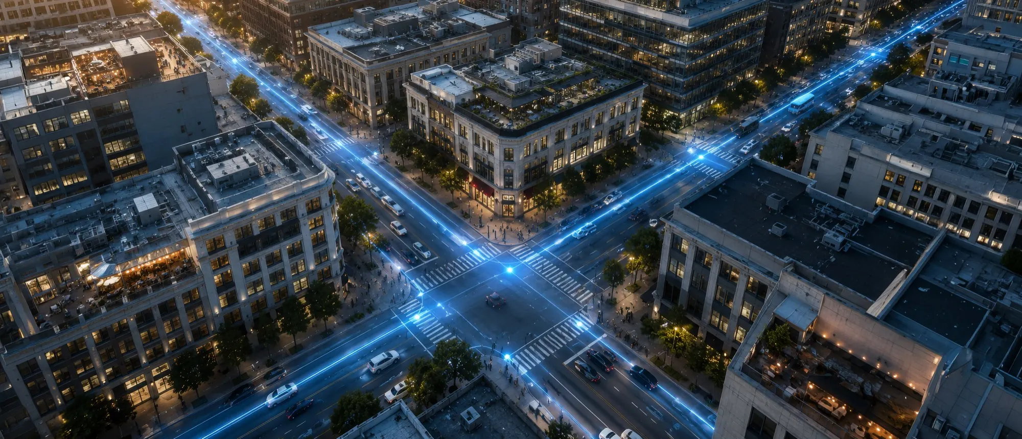 Aerial view of a city intersection at night with traffic traced in blue light